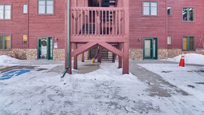 A multi-story building with a central staircase and a balcony. - Patio & Mountain Views: Central Grand Lake Condo! (Grand Lake)