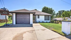 A residential house with a garage, a basketball hoop, and a well-maintained lawn. - Lakefront Family Home w/ Boat Dock + Slip in Texas (Trinidad)