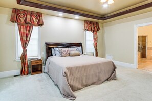 A bedroom with a large bed, two nightstands, and a window with curtains. - 8 Mi to Dtwn: Expansive Estate in Gettysburg! (Gettysburg)