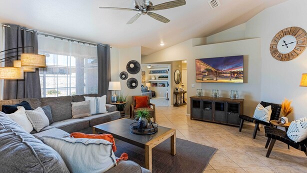 A modern living room with a sofa, coffee table, and dining area.
