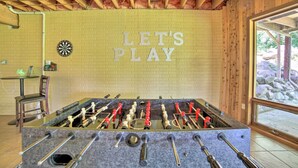 A foosball table in a room with a wooden ceiling and a wall that says "LET'S PLAY". - Grand Escape w/ Deck, Game Room, Nature View! (Brooklyn)