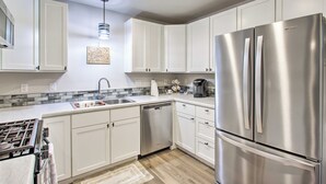 A modern kitchen with white cabinets, stainless steel appliances, a dishwasher, and a coffee maker. - 1 Mi to Winery: Clifton Escape w/ Grill & Yard! (Clifton)