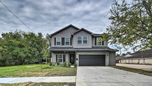 A two-story residential house with a garage, a front yard, and a driveway. - Chic Houston Home w/ Game Room ~ 8 Mi to Dtwn (Houston)