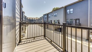 A residential building with a balcony, a street view, and a clear sky. - Updated Charlotte Vacation Rental 4 Mi to Downtown (Charlotte)