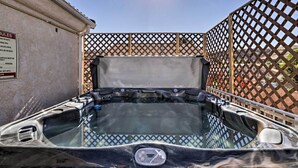 A hot tub with a digital temperature display, surrounded by a wooden lattice fence. - Home w/ Game Room & Fire Pit: 30 Min to Zion! (La Verkin)
