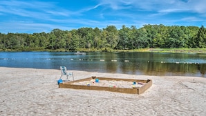 A sandy beach area with a wooden sandbox and beach chairs. - Mtn Getaway w/ Indoor Hot Tub, Golfers Welcome! (White Haven)