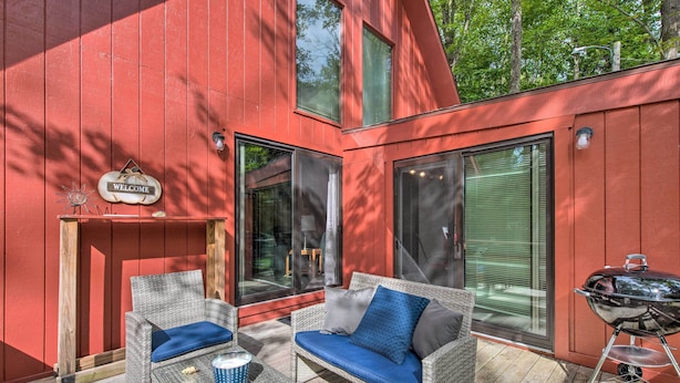 A red building with a 'WELCOME' sign, outdoor seating with cushions, and a barbecue grill. - Mtn Getaway w/ Indoor Hot Tub, Golfers Welcome! (White Haven)