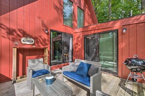A red building with a 'WELCOME' sign, outdoor seating with cushions, and a barbecue grill. - Mtn Getaway w/ Indoor Hot Tub, Golfers Welcome! (White Haven)