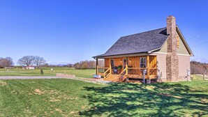 A wooden cabin with a porch, chimney, and a grassy yard. - Near Wineries & Hiking: Lawndale Home w/ Fire Pit! (Lawndale)