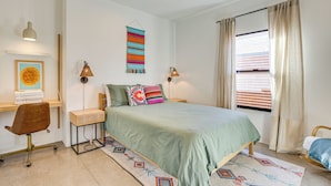 A bedroom with a bed, a desk, a chair, a ceiling fan, and a window with curtains. - Families Welcome: Phoenix Home w/ Backyard Oasis (Phoenix)