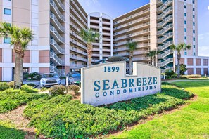 A sign for Seabreeze Condominiums with a modern building in the background. - Spacious Biloxi Getaway w/ Pools & Beach Access! (Biloxi)