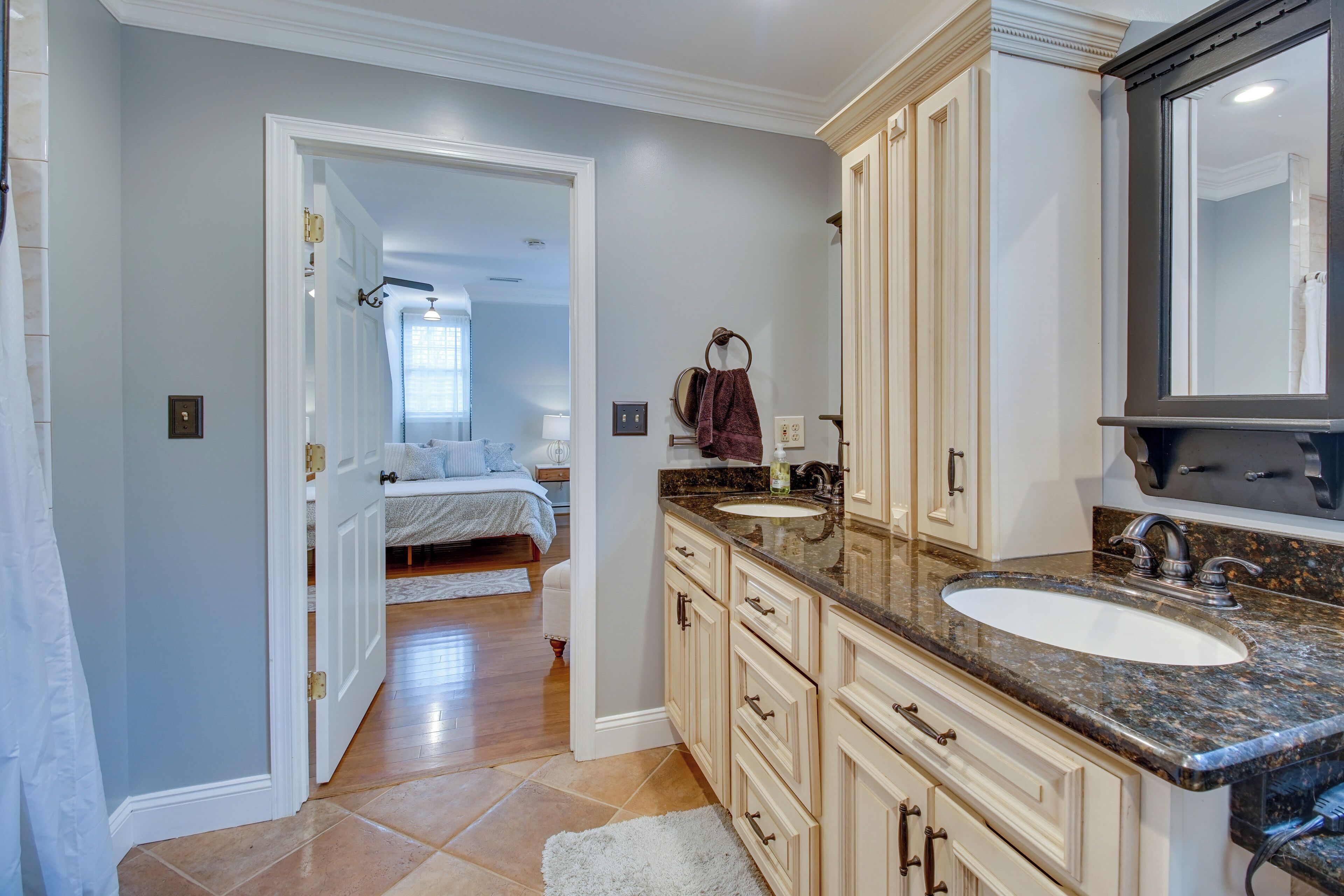 A modern bathroom with a large sink, vanity, and mirror.