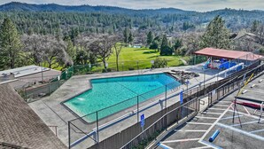 A swimming pool with a view of a golf course and forested hills in the background. - California Cabin w/ Lake Access: 28 Mi to Yosemite (Groveland)