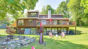 A two-story house with a deck, a fireplace, and outdoor seating. - Pet-friendly Vacation Rental w/ Lake Access (Newton)