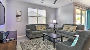 A living room with two grey sofas, a coffee table, a TV, and a lamp. - Quiet Family Home w/ Yard ~ 3 Mi to Luke Afb! (Glendale)