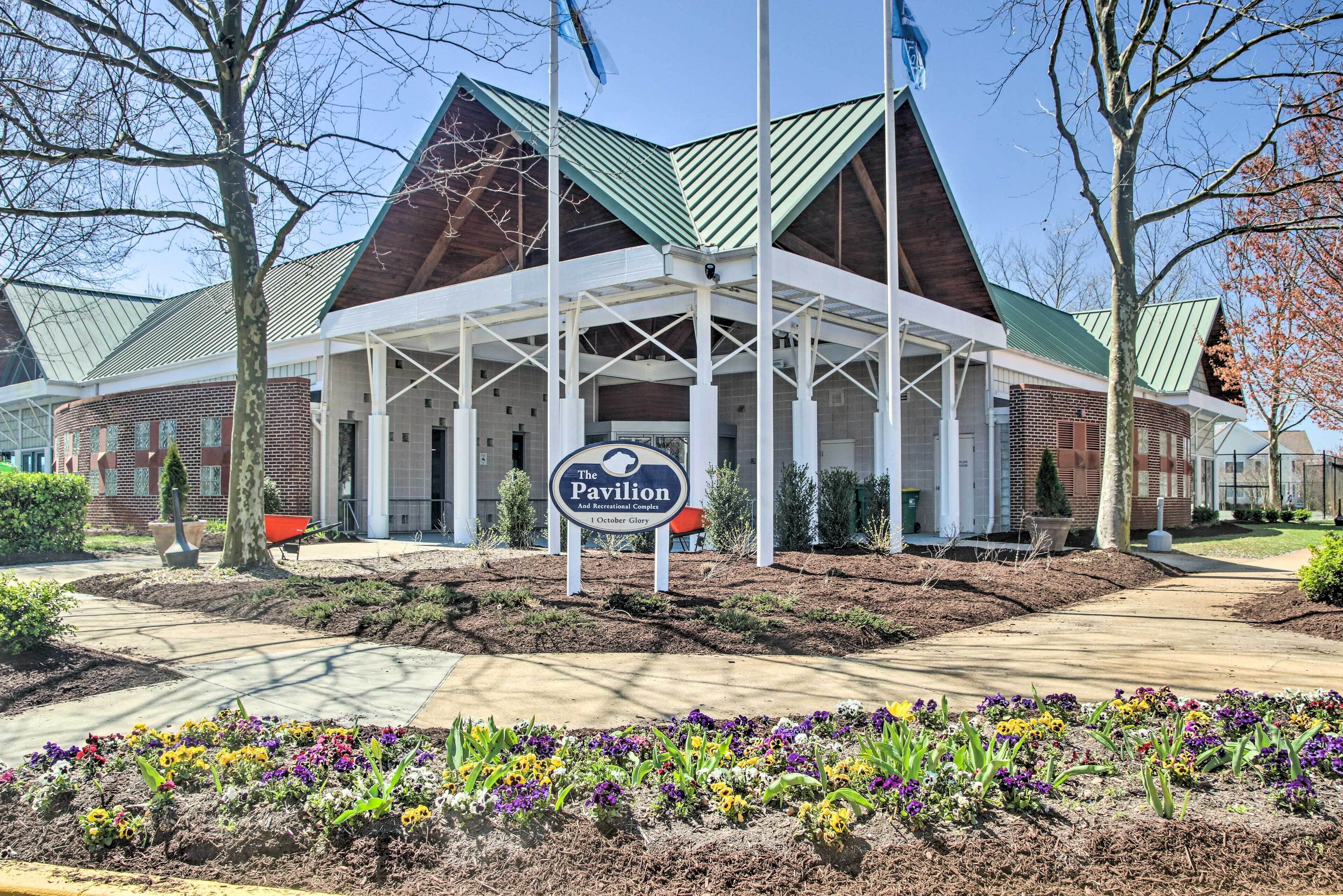 A building with a sign reading "The Pavilion And Recreational Complex" with a covered entrance and a brick facade.