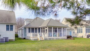 A two-story house with a covered porch, a fenced yard, and a blue door. - 2 Mi to Beach: Ocean View Oasis w/ Resort Access! (Ocean View)