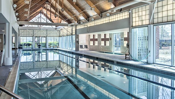 An indoor swimming pool with a high ceiling, large windows, and a view of the outside. - 2 Mi to Beach: Ocean View Oasis w/ Resort Access! (Ocean View)