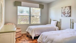 A bedroom with two beds, a window, a chair, and a painting on the wall. - Pet-friendly Home w/ Patio - 3 Mi to Houston Zoo! (Houston)
