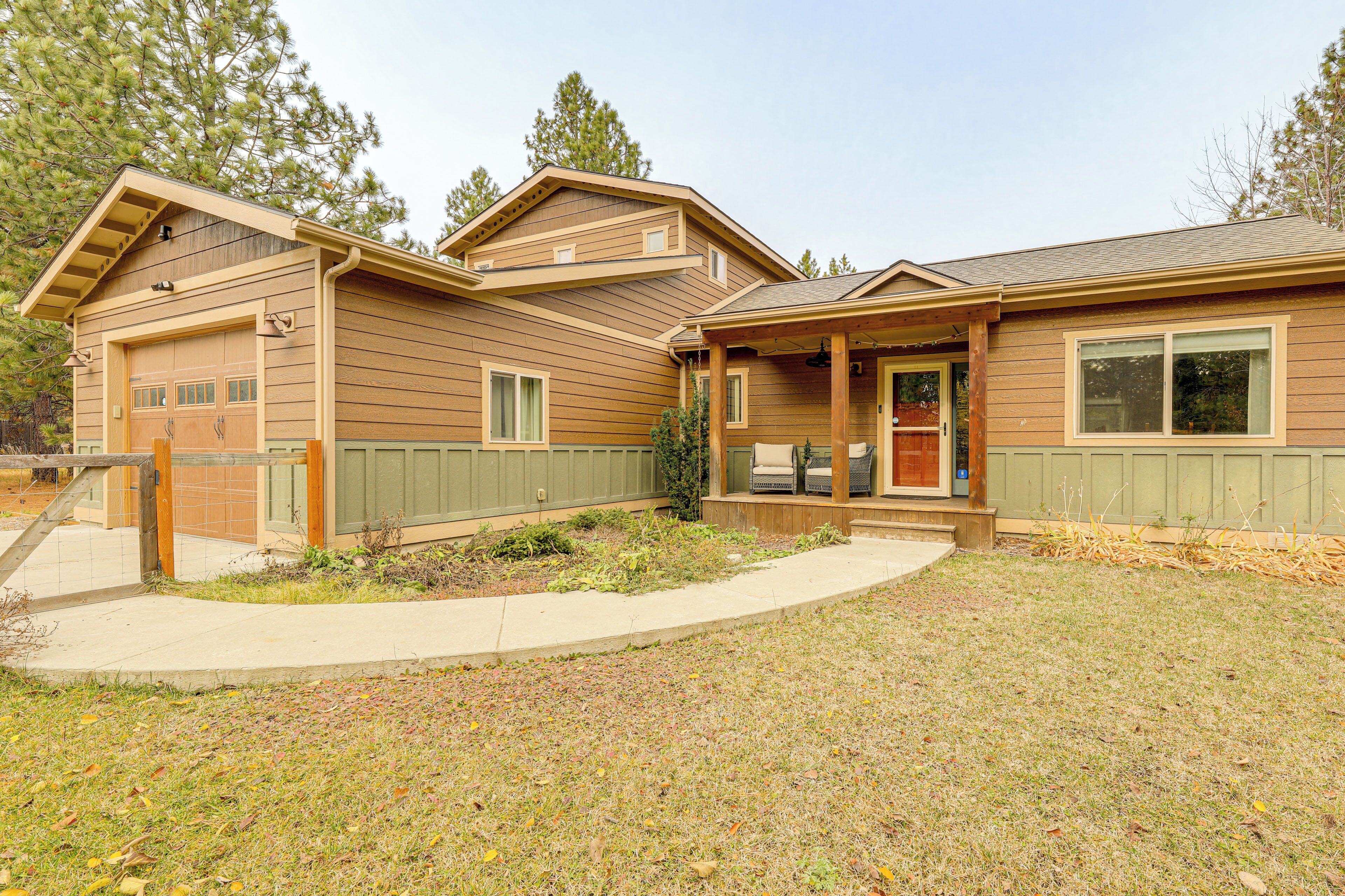 A two-story house with a garage, a covered porch, and a small front yard.