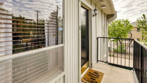 A residential building with a covered porch, a door with a doormat, and a view of the neighborhood. - Chic Dallas Condo w/ Pool, Walk to Knox Street! (Dallas)