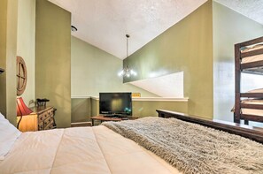 A bedroom with a bed, a television, a dresser, and a window. - Brian Head Condo w/ Shared Pool & Hot Tub! (Brian Head)