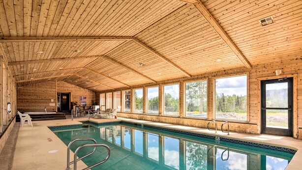 An indoor swimming pool with wooden walls and large windows. - Brian Head Condo w/ Shared Pool & Hot Tub! (Brian Head)