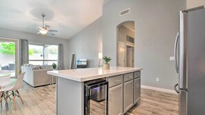 A modern kitchen with a built-in dishwasher, stainless steel appliances, and a light gray color scheme. - Private Pool & Community Perks: Mesa Home! (Mesa)