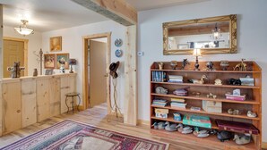 A cozy room with a wooden bookshelf, a mirror, and a rug. - Cozy Dolores Getaway: Hike, Fish + More! (Dolores)