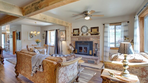 A spacious living room with a fireplace, wooden beams, and classic furniture. - Cozy Dolores Getaway: Hike, Fish + More! (Dolores)