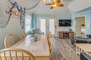 A dining area with a wooden table, chairs, and a decorative bowl.