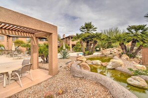 A patio area with outdoor seating, a small pond, and surrounding landscaping. - Resort Perks & Private Balcony: Scottsdale Condo! (Scottsdale)