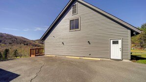 A single-story building with a gabled roof, a small window, and a door. - Deck, Grill & Mountain Views: Banner Elk Retreat! (Banner Elk)