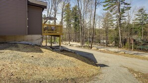 A building with a covered deck and a gravel driveway. - Chestertown Hideaway w/ Lake & Beach Access! (Chestertown)
