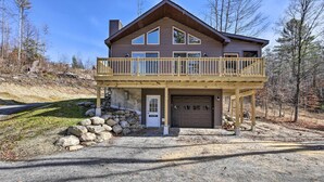 A two-story house with a balcony, a garage, and a stone wall. - Chestertown Hideaway w/ Lake & Beach Access! (Chestertown)