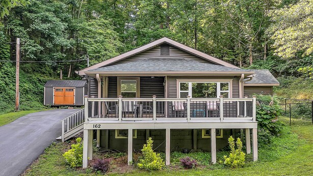 A two-story house with a balcony, a small attached garage, and a well-maintained lawn. - Pet-friendly Pickens Vacation Rental w/ Fire Pit (Pickens)