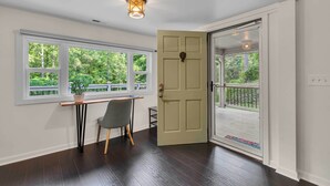 A room with a desk, chair, and a door leading to a balcony. - Pet-friendly Pickens Vacation Rental w/ Fire Pit (Pickens)