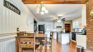 A kitchen with wooden furniture, a ceiling fan, and a sign that says "Happiness is homemade." - Cozy Lewiston Home < 10 Mi to Niagara Falls! (Lewiston)