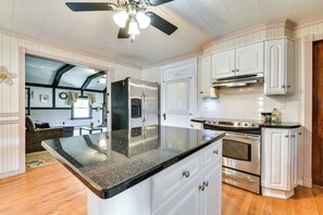 Enjoy cooking in this well-equipped kitchen with a central island, oven, and stovetop.