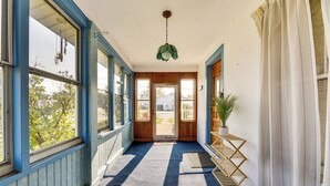 A hallway with a blue carpet, wooden doors, and a hanging light fixture. - Cozy Lewiston Home < 10 Mi to Niagara Falls! (Lewiston)