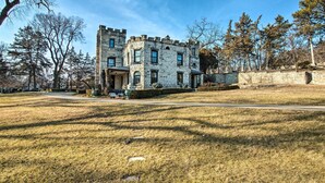 A historic stone building with a symmetrical facade, large windows, and a central entrance. - Historic Guest House on Castle Kimble Estate! (Manhattan)