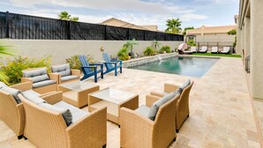 A poolside area with wicker furniture and a view of the pool. - Lake Havasu City Escape w/ Pool, Patio & Grill! (Lake Havasu City)