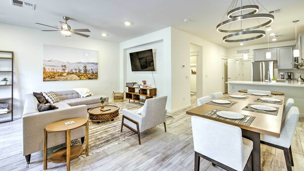 A modern living room with a sofa, coffee table, and TV wall mount. - 6 Mi to Dtwn Chandler: Newly Built Townhome (Chandler)