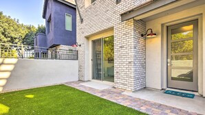 A modern building with a brick facade, a glass door, and a welcome mat. - 6 Mi to Dtwn Chandler: Newly Built Townhome (Chandler)