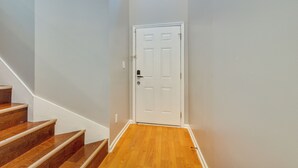 A staircase leading to a white door with a small window above it. - Huntsville Vacation Rental < 5 Mi to Airport! (Huntsville)