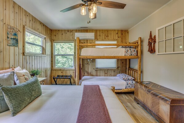 A cabin-style room with a bunk bed, a desk, and a ceiling fan. - Rustic Oakhurst Retreat < 4 Mi to Bass Lake! (Oakhurst)