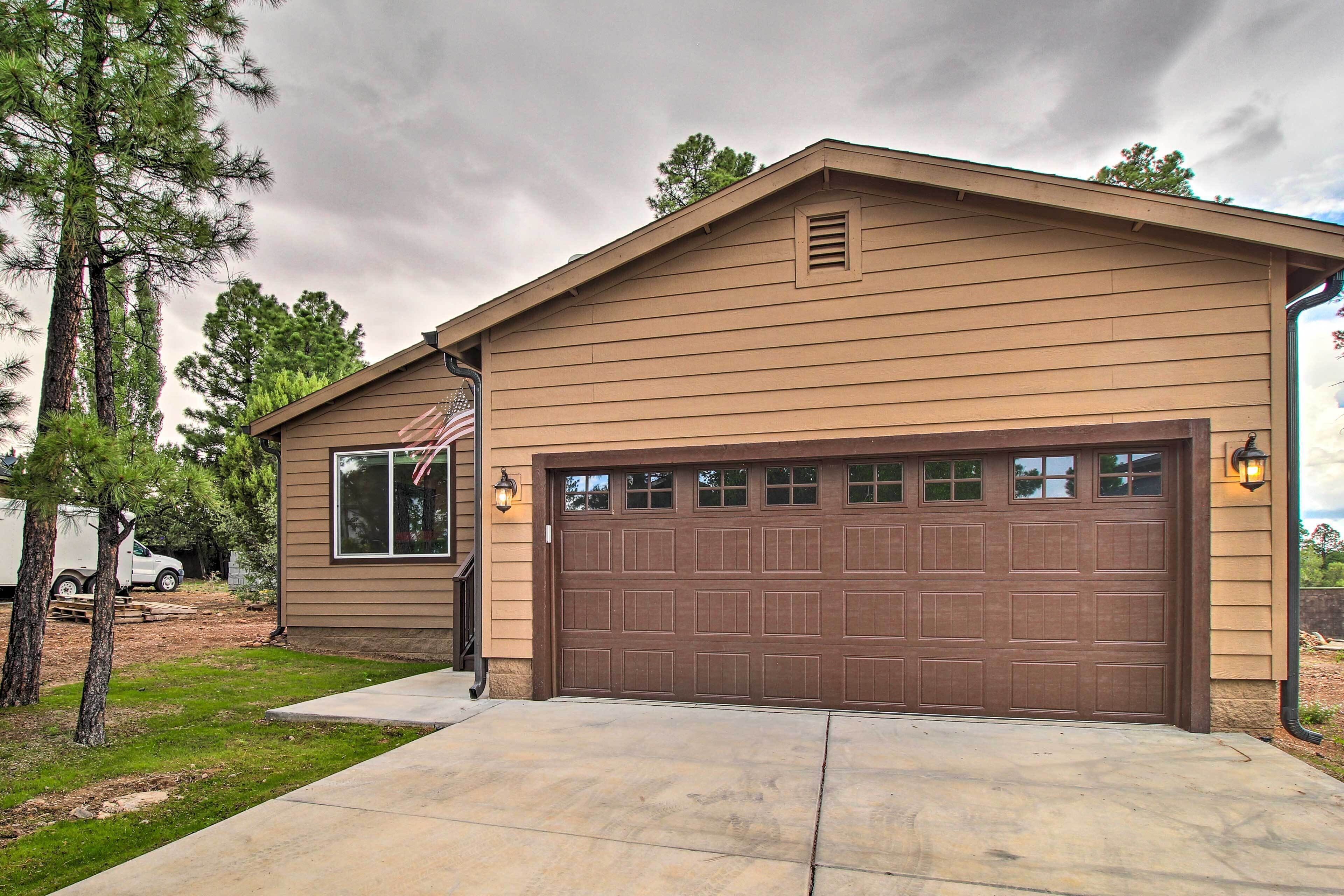 A two-story house with a brown garage door, a front porch, and a driveway.