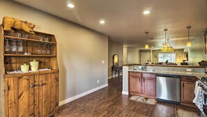 A spacious kitchen with wooden cabinets, a stainless steel dishwasher, and a central island.