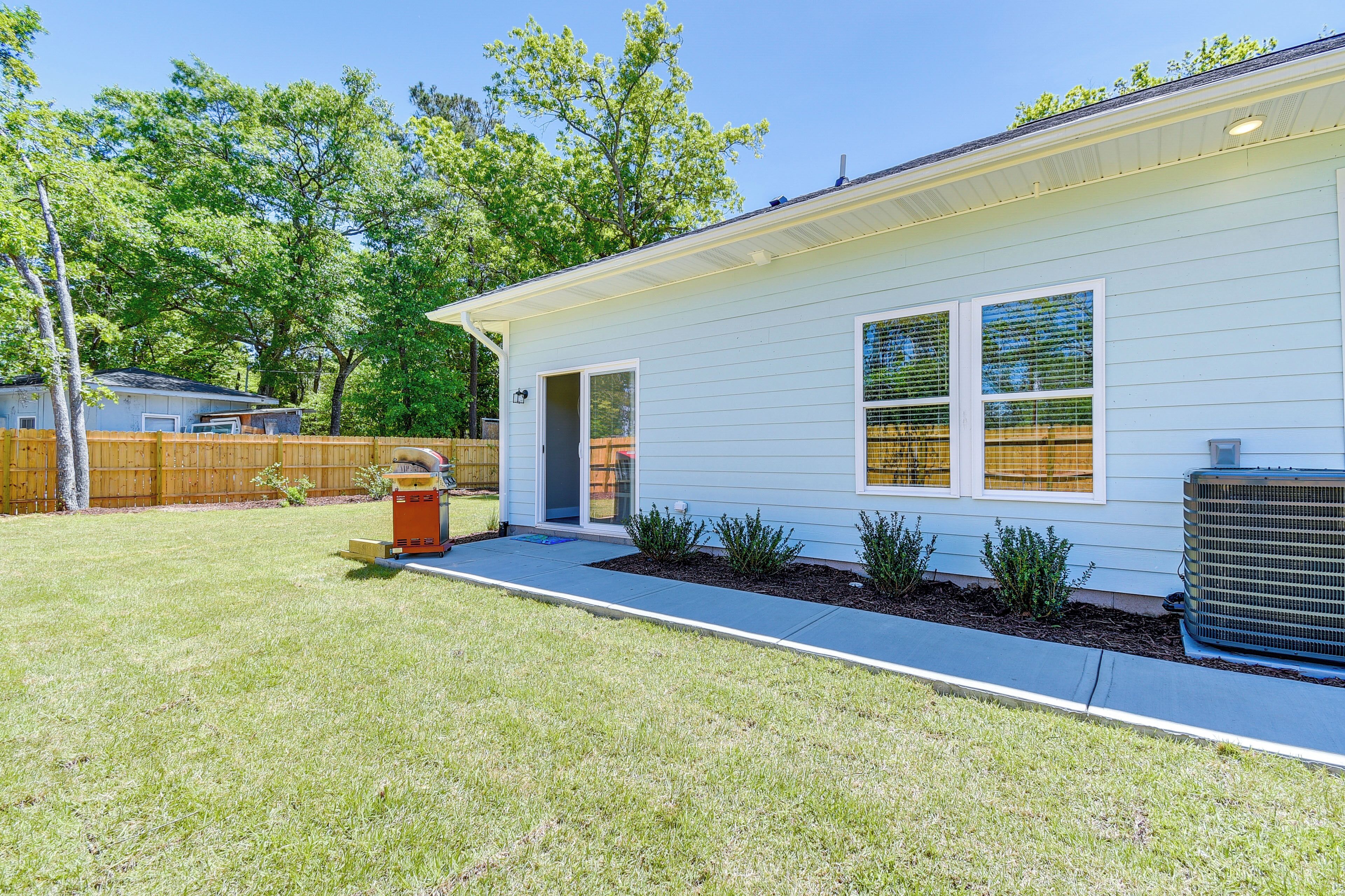 A single-story house with a front door, a small porch, and a visible air conditioning unit.