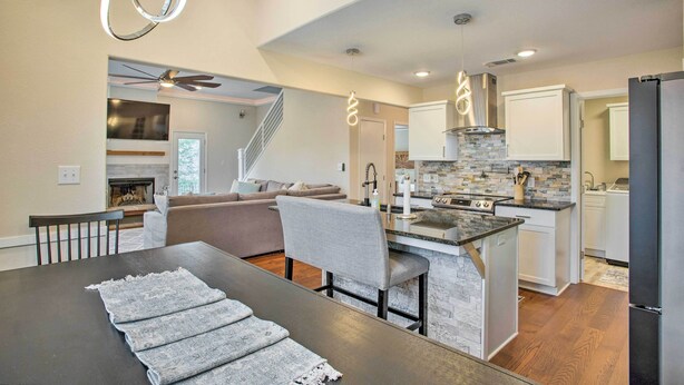 A modern kitchen with a central island, built-in appliances, and a dining area with a table and chairs. - Wooded Pottsboro Escape ~ 1 Mi to Lake Texoma (Pottsboro)